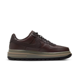 Brown sneaker with a white sole on a transparent background